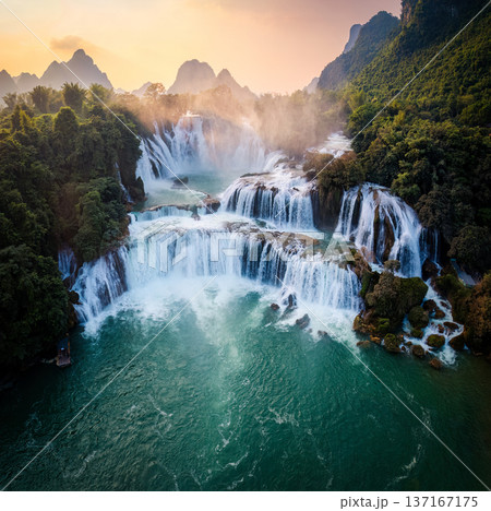 Majestic Ban Gioc waterfall, Detian Falls flowing in tropical forest during the sunset at Cao Bang, Vietnam Majestic Ban Gioc waterfall, Detian Falls flowing in tropical forest during the sunset at Cao Bang, Vietnam 137167175