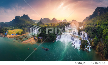 Majestic Ban Gioc waterfall, Detian Falls flowing in tropical forest during the sunset at Vietnam 137167183