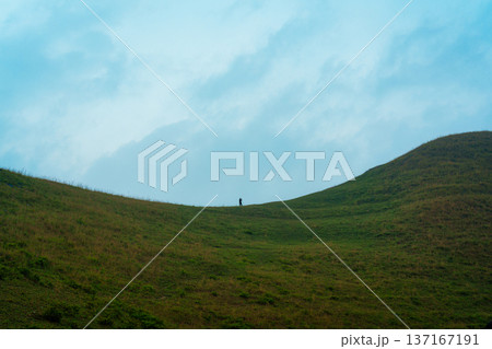 A man standing on grassland hill in countryside at Vietnam 137167191