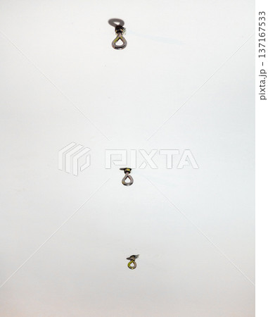 hammock hooks on a white ceiling. Metal mount on the ceiling. Reliable fastening. hammock hooks on a white ceiling. Metal mount on the ceiling. Reliable fastening. 137167533