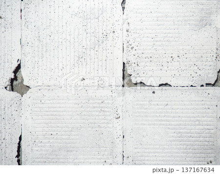 background of broken white tiles. The wall needs repairs. The concept of ruin and abandonment. Chipped tile. background of broken white tiles. The wall needs repairs. The concept of ruin and abandonment. Chipped tile. 137167634