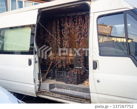 Selling dried persimmons from a car. Dried fruits in the car. The car is like a counter. 137167752