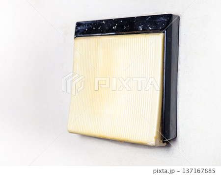 Old plastic wall light switch. Vintage device. Part of home interior. 137167885