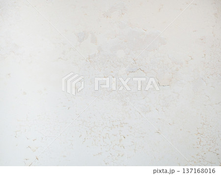 Ceiling of an old apartment. Crumbling plaster. The housing requires renovation. Background made of peel-off coating. 137168016
