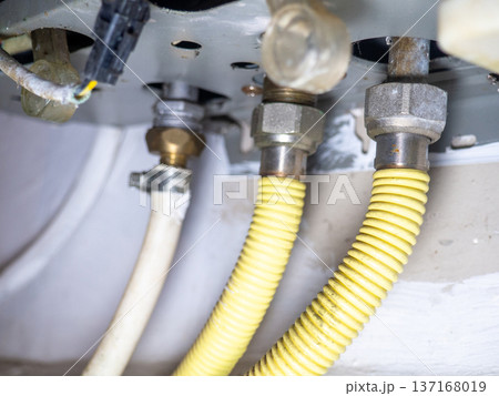 Part of gas equipment. Hoses in a gas water heater. Gas flows through these pipes at home. 137168019