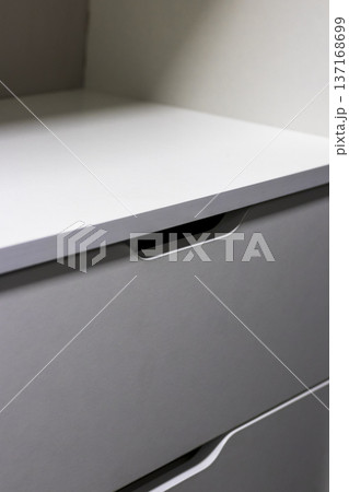 Modern shelving unit with a drawers in a wardrobe 137168699