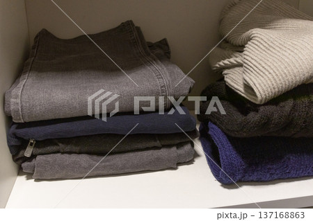 A stack of folded jeans and casual clothing A stack of folded jeans and casual clothing 137168863