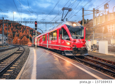 Red modern train on mountain railway station in Swiss Alps 137169433