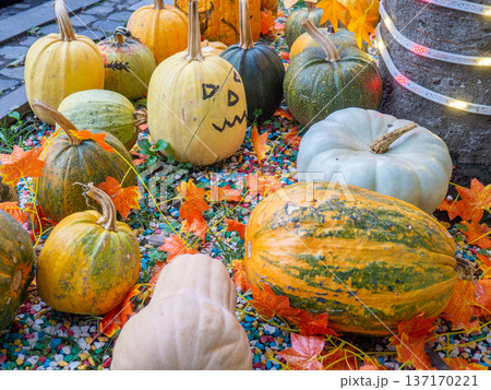 Decorations for Halloween on the street near the restaurant. Autumn holiday decorations. Illuminations. Restaurant patio decoration. Painted multi-colored pumpkins. All Saints' Day. The holiday is 137170221