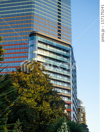 Modern construction of a high-rise building. Modern architecture of a business center. Apartment in a high-rise building. 137170241