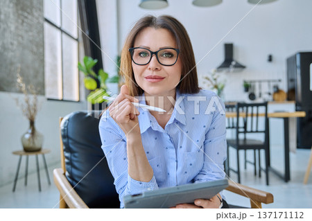 Webcam view woman entrepreneur, teacher working online remotely in home office Webcam view woman entrepreneur, teacher working online remotely in home office 137171112