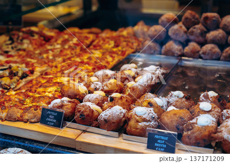 Pizzas and pastries in a bakery display at a busy street in the morning Pizzas and pastries in a bakery display at a busy street in the morning 137171209