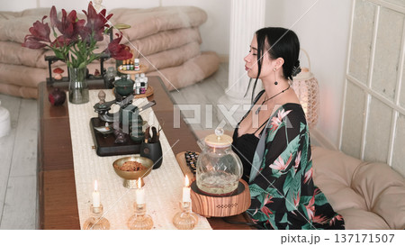 Female meditation. Spiritual zen. Aesthetic girl practicing calming yoga enjoying oriental aromatherapy with candles peaceful indoor. 137171507