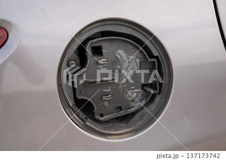 Detailed view of the internal plastic mechanism of a missing car fuel filler flap 137173742