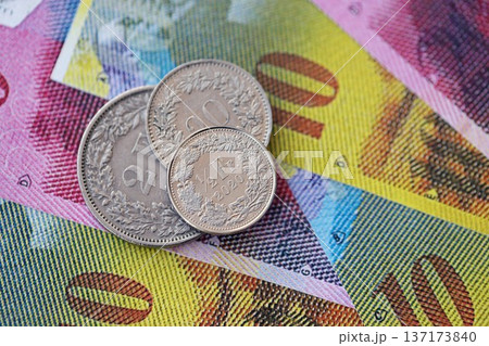 Currency of Switzerland. Banknotes and Swiss franc coins on them. Financial topics in Swiss banking concept. Currency of Switzerland. Banknotes and Swiss franc coins on them. Financial topics in Swiss banking concept. 137173840
