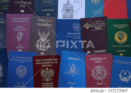 Big amount of passports of various different countries. Covers of expired passports close up. Travel documents for tourism Big amount of passports of various different countries. Covers of expired passports close up. Travel documents for tourism 137173907