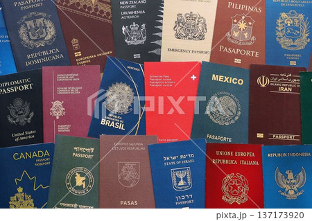 Big amount of passports of various different countries. Covers of expired passports close up. Travel documents for tourism Big amount of passports of various different countries. Covers of expired passports close up. Travel documents for tourism 137173920