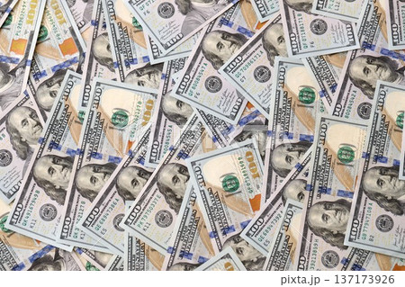 Stacks of hundred dollar bills showcase intricate designs on a flat surface. Money background with Franklin on the 100-dollar note Stacks of hundred dollar bills showcase intricate designs on a flat surface. Money background with Franklin on the 100-dollar note 137173926