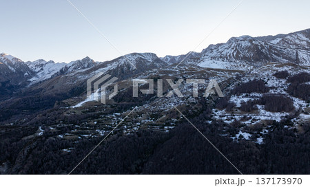 Aerial view of snowy mountain peaks and rocky slopes in the Pyrenees during winter twilight Aerial view of snowy mountain peaks and rocky slopes in the Pyrenees during winter twilight 137173970