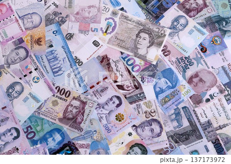 Big amount of various currencies money bills banknotes in full frame. Many cash bills from different countries in big pile close up. World economy and currency exchange concept Big amount of various currencies money bills banknotes in full frame. Many cash bills from different countries in big pile close up. World economy and currency exchange concept 137173972