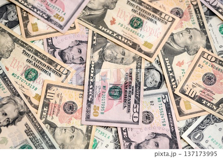 American dollars in one hundred banknotes. Lot of dollars close up. Stack of dollars and cash with a money background. American dollars in one hundred banknotes. Lot of dollars close up. Stack of dollars and cash with a money background. 137173995