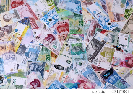 Different banknotes from many currencies of the whole world. Big pile of money bills close up Different banknotes from many currencies of the whole world. Big pile of money bills close up 137174001