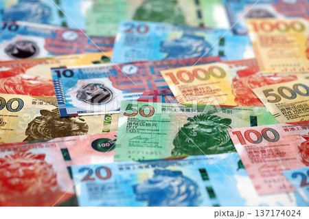 Big pile of Hong Kong dollars money bills banknotes close up. Lots of money of Chinese Hong Kong HKD currency cash in big bunch. Economics and business in HongKong 137174024