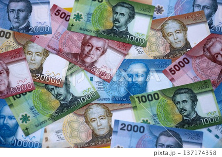 Big amount of chilean pesos money bills banknotes. Huge quantity of paper money from Chile country close up. Concept of business and economy in Chile Big amount of chilean pesos money bills banknotes. Huge quantity of paper money from Chile country close up. Concept of business and economy in Chile 137174358