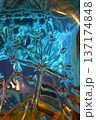 Abstract glass flower in blue and gold tones with translucent details, organic shapes. Teal abstract glass texture, liquid pattern, translucent surface, reflections. Teal abstract design background 137174848