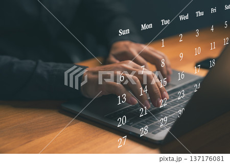 Hand typing on laptop with virtual calendar dates, representing online scheduling, time management, business planning, deadline organization, productivity workflow, and digital work efficiency concept Hand typing on laptop with virtual calendar dates, representing online scheduling, time management, business planning, deadline organization, productivity workflow, and digital work efficiency concept 137176081