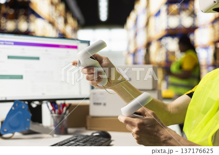 Asian man clerk uses virtual reality headset to manage order processing and parcel status, AI powered setup enhances logistics and fast delivery operations with virtual reality tools. Asian man clerk uses virtual reality headset to manage order processing and parcel status, AI powered setup enhances logistics and fast delivery operations with virtual reality tools. 137176625