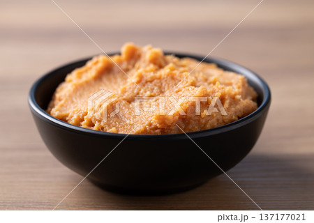 Miso paste in a black bowl on a rustic wooden table Miso paste in a black bowl on a rustic wooden table 137177021