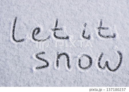 Written LET IT SNOW on snow background message ice outdoor on ground in winter. Writing text sign and drawing on field in frozen background. Weather is changing cold season has arrived. Mockup Copy Written LET IT SNOW on snow background message ice outdoor on ground in winter. Writing text sign and drawing on field in frozen background. Weather is changing cold season has arrived. Mockup Copy 137180237