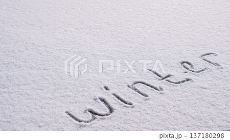 Written WINTER on snow background message ice outdoor on ground in winter. Writing text sign and drawing on field in frozen background. Weather is changing cold season has arrived. Mockup Copy space Written WINTER on snow background message ice outdoor on ground in winter. Writing text sign and drawing on field in frozen background. Weather is changing cold season has arrived. Mockup Copy space 137180298