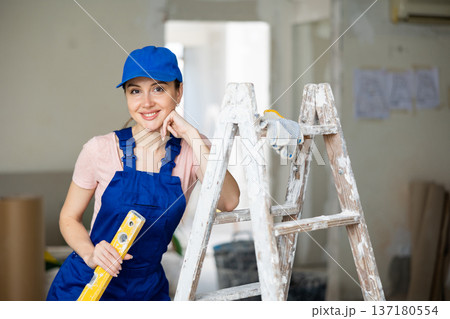 Female worker posing in apartment being renovated Female worker posing in apartment being renovated 137180554