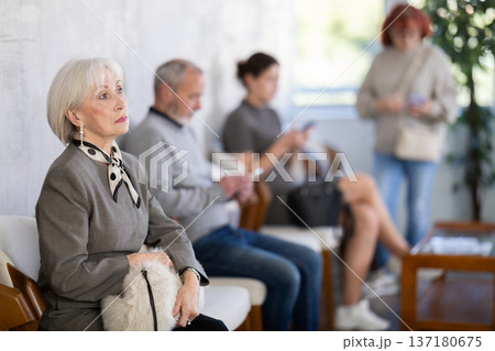 Elderly woman waiting in line during visit to medical center 137180675