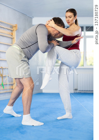 Adult man and young woman training self-defense techniques 137180729
