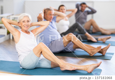 Elderly woman doing pilates in group Elderly woman doing pilates in group 137181068