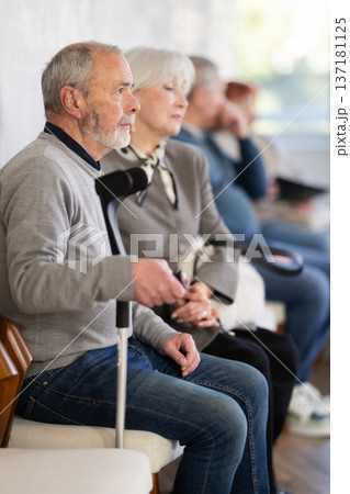 Elderly man waiting in line during visit to medical center 137181125
