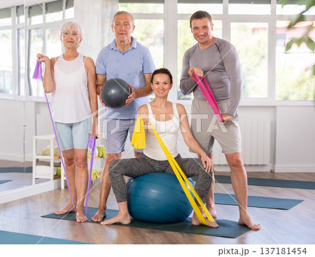 Coach and elderly visitors of fitness course smile happily after training 137181454