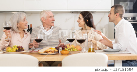 Elderly parents with adult children enjoying family dinner Elderly parents with adult children enjoying family dinner 137181594