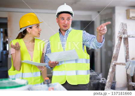 Woman architect and man engineer discussing work plan in apartment Woman architect and man engineer discussing work plan in apartment 137181660