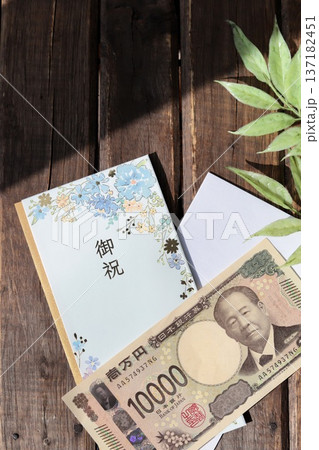 水色で花柄のご祝儀袋と新札の一万円 水色で花柄のご祝儀袋と新札の一万円 137182451