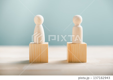 A minimalist team concept, business strategy with two wooden pawns on blocks representing human resource management or partnership for a successful modern business 137182943
