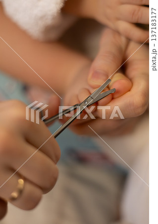Cutting nails during a baby grooming session at home in the afternoon Cutting nails during a baby grooming session at home in the afternoon 137183177