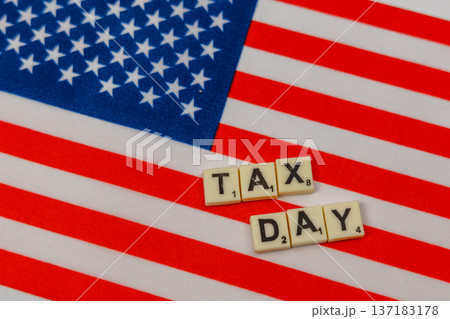 Celebrate National Scrabble Day with tax day letters on a flag 137183178