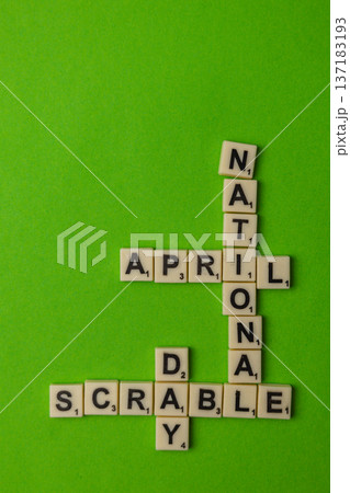 National Scrabble Day celebration with game tiles on bright green background National Scrabble Day celebration with game tiles on bright green background 137183193