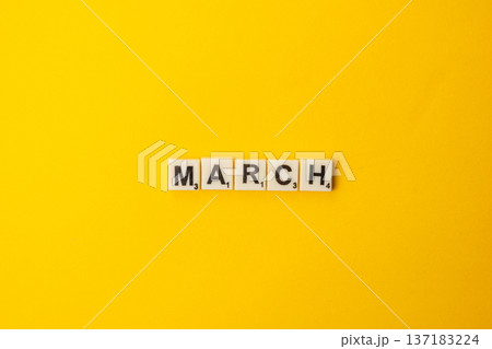 Celebration of National Scrabble Day with letter tiles on yellow background 137183224