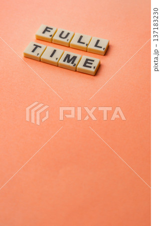 Celebrate National Scrabble Day with word tiles on an orange background 137183230