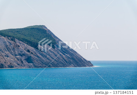 High mountain slopes to the Black Sea coast in Anapa, Russia. Coastline in sunset, beautiful sea scenery. Anapa coast landscape, high cliff High mountain slopes to the Black Sea coast in Anapa, Russia. Coastline in sunset, beautiful sea scenery. Anapa coast landscape, high cliff 137184151